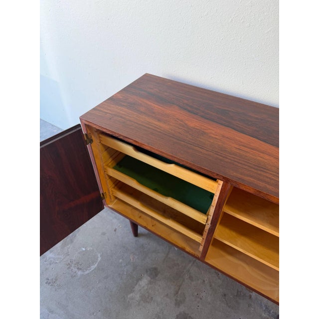 Elegant Mid Century Modern Danish sideboard designed by Poul Hundevad, crafted in beautifully figured rosewood and...