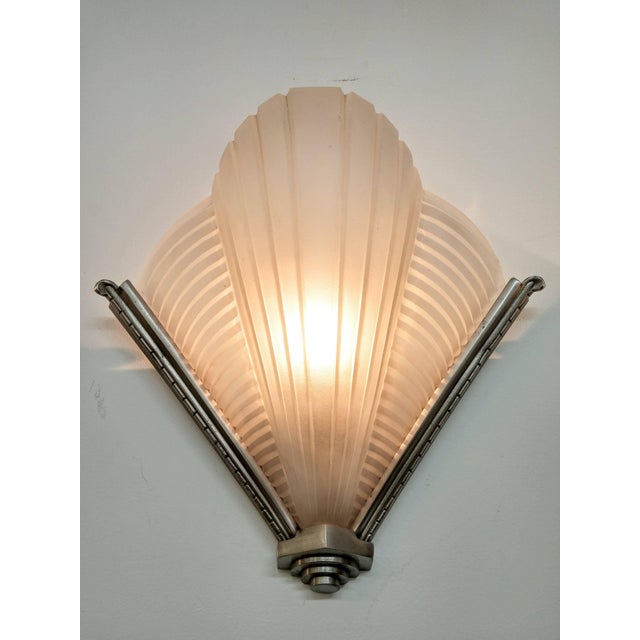 A pair of French Art Deco wall sconces by the French artist " Petitot " in clear frosted glass with vertical and...