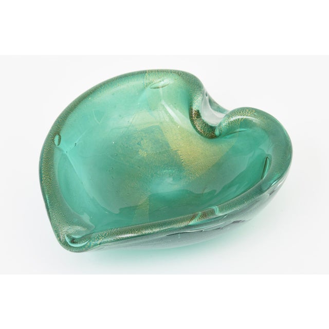 This Mid Century Modern Italian Murano glass bowl is the beautiful shade of emerald sea green with gold aventurine...