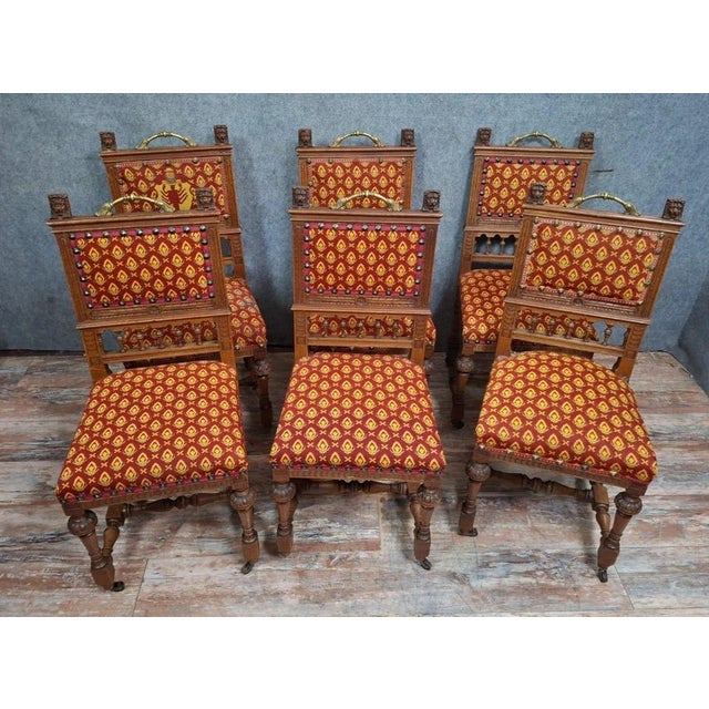 A set of six renaissance-style carved oak chairs dating from the late 19th century. these elegant chairs feature a richly...