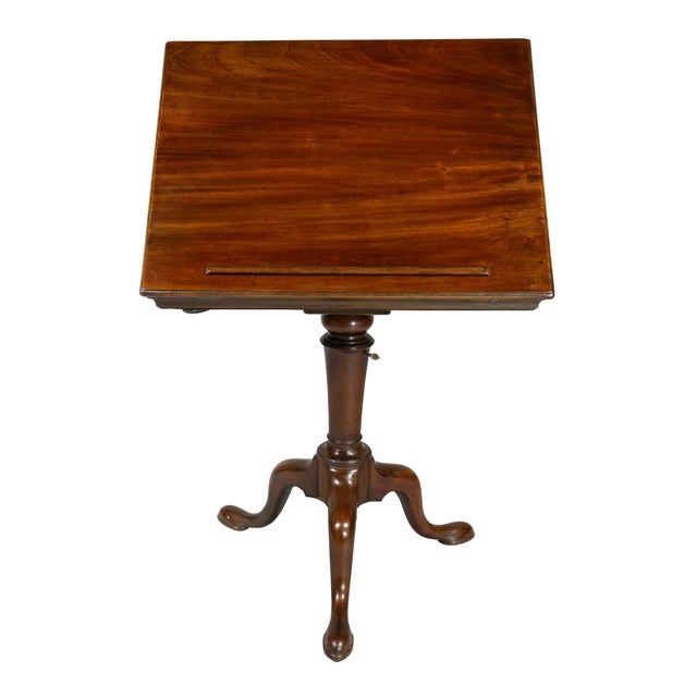 With rectangular hinged adjustable top over a turned support and candleholder, tripartite cabriole legs and pad feet.