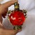 This is a vintage snuff bottle crafted from vibrant red glass with a textured, speckled interior. The bottle is encased in...