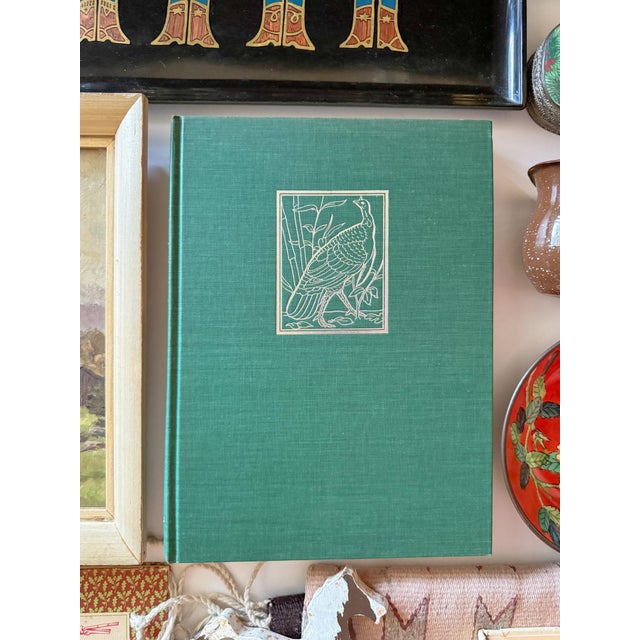 Stunning, large green linen hardcover coffee table book with dust jacket. Numerous beautifully designed color plates...