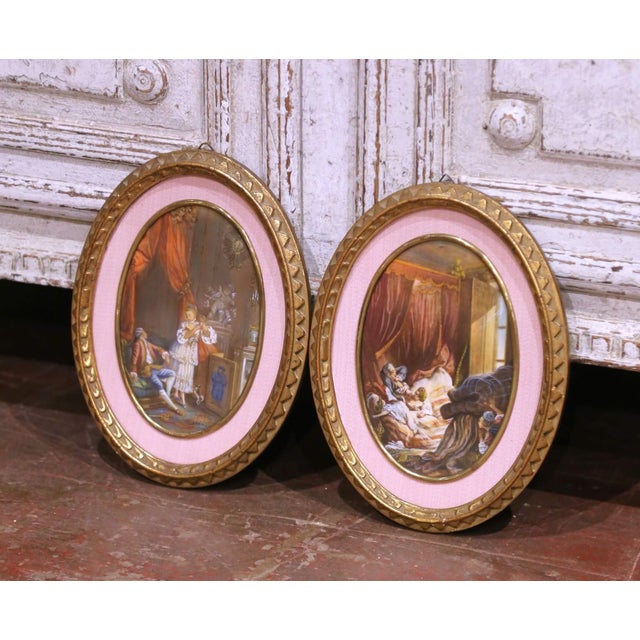 This elegant pair of antique wall pendants was crafted in France circa 1960 and features hand-painted genre scenes...