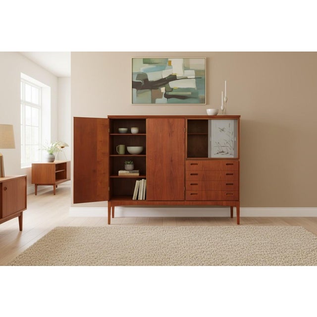 A fantastic Danish teak cabinet from the mid-1960s that combines elegant design with unusually generous storage options on...