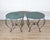 A beautiful pair of round iron tables, late 19th to early 20th century, featuring gracefully shaped legs and original...