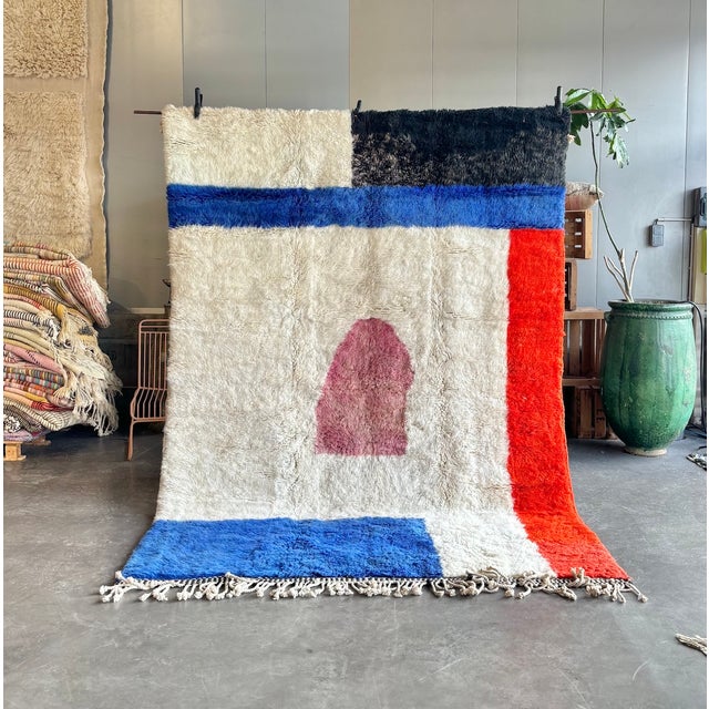 This Beni M'rirt rug was hand-knotted by Berber artisans in the Middle Atlas Mountains of Morocco. The ivory high-pile...