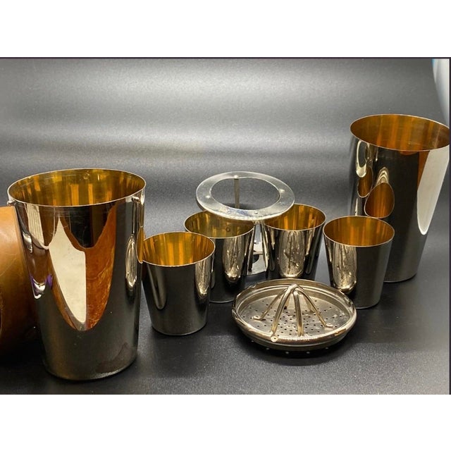 What a find! A complete vintage German Travel Cocktail Shaker with strainer Mix Top and complete nesting cups. The leather...