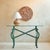 A French Neoclassical Revival iron console table from the 1980s. An elongated oval glass top appears to float lightly...