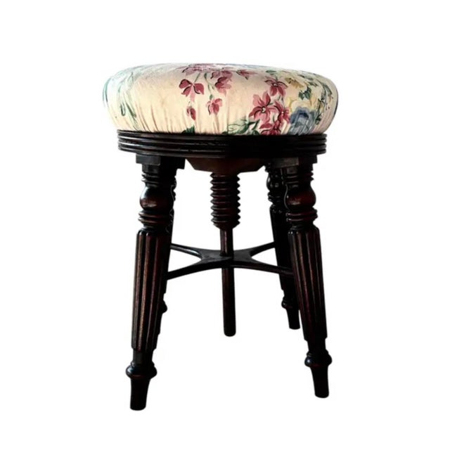 Adjustable English Mahogany Stool. Stool is crafted in rich mahogany and features a floral upholstered seat. It is raised...