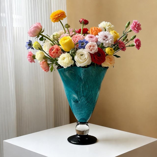 This hand-blown glass vase seals the flowing lake blue texture in the transparent glass body, and the swirling smudged...