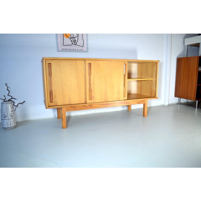 This is a rare vintage sideboard from Denmark. The sideboard has a unique patina and lends the room an honest and serene...
