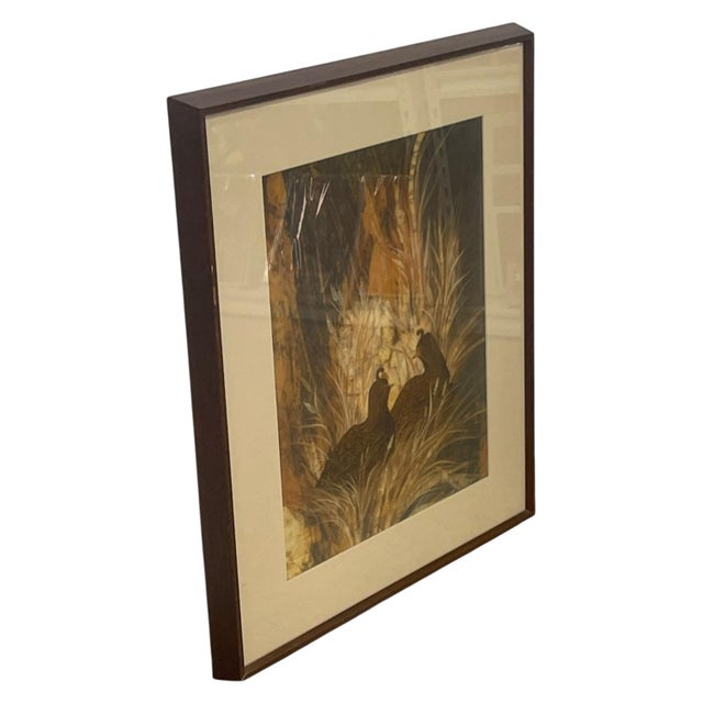 Signed batik artwork by artist Louise "Lou" Wilson depicting two quail nestled among tall grasses and vegetation. The...
