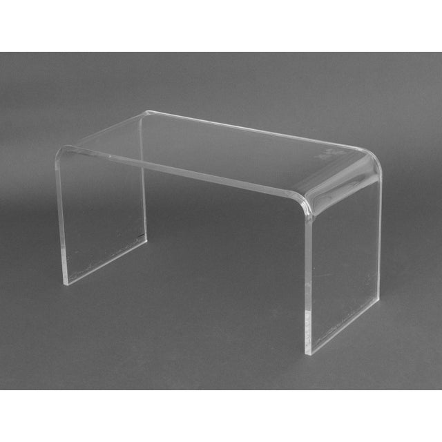 Modern Clear Acrylic Waterfall Coffee Table. 18" H x 30" W x 14" D. Provenance: From a Sutton Place Collection.