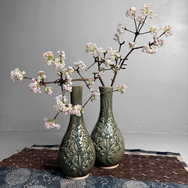 This pair of slender ikebana vases features an elegant, slightly flared neck and a beautifully balanced, pear-shaped body....