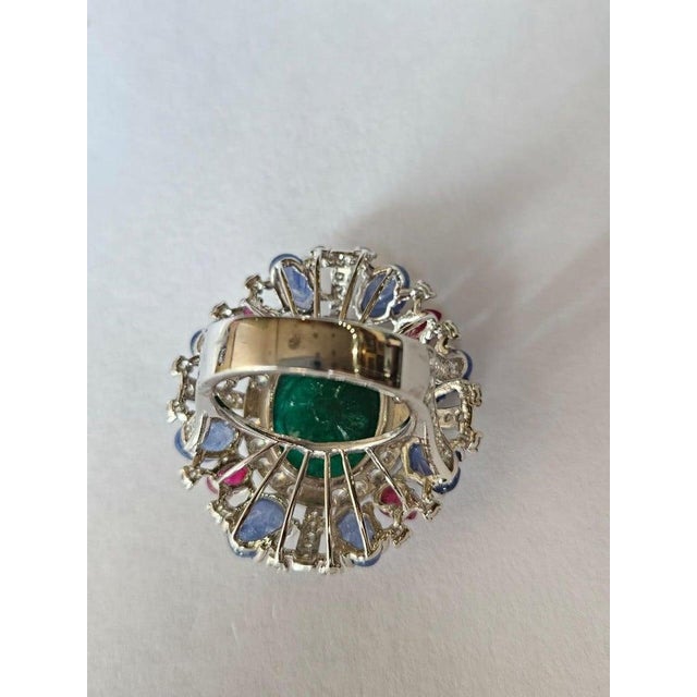 A very gorgeous and beautiful, one of a kind, Emerald, Blue Sapphires & Rubies Cocktail Ring set in 18K White Gold &...