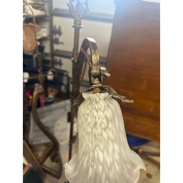 An elegant early 20th-century bridge arm floor lamp featuring elaborate cast-metal ornamentation, an octagonal pierced...