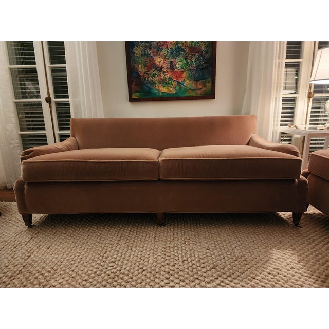 William Alan custom designed pair of caramel colored mohair sofas. The front has three brass casters and 2 back legs which...