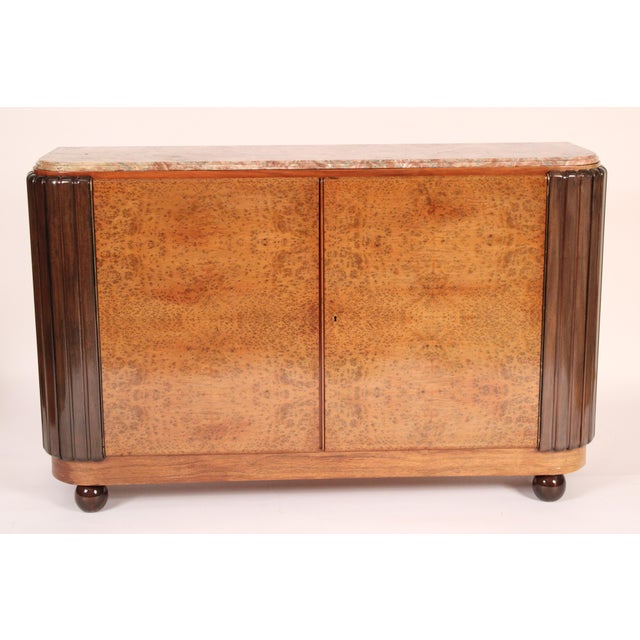 Art deco burl ash two door marble top cabinet, circa 1950. With a rectangular marble top with rounded front corners,...