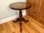 A round mahogany pedestal Maitland Smith side table with an inlaid marquetry radiating satinwood floral pattern, fluted,...