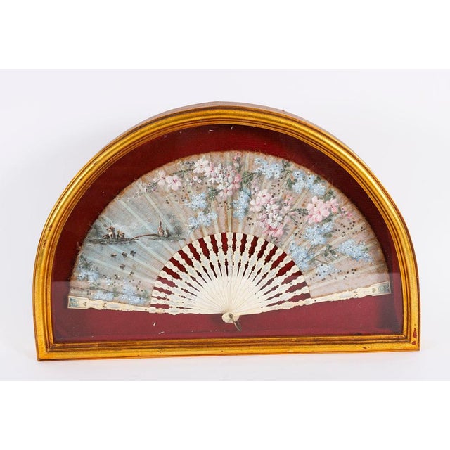 This is a truly splendid antique and highly decorative French hand painted silk fan set in a gilded and glazed box frame,...