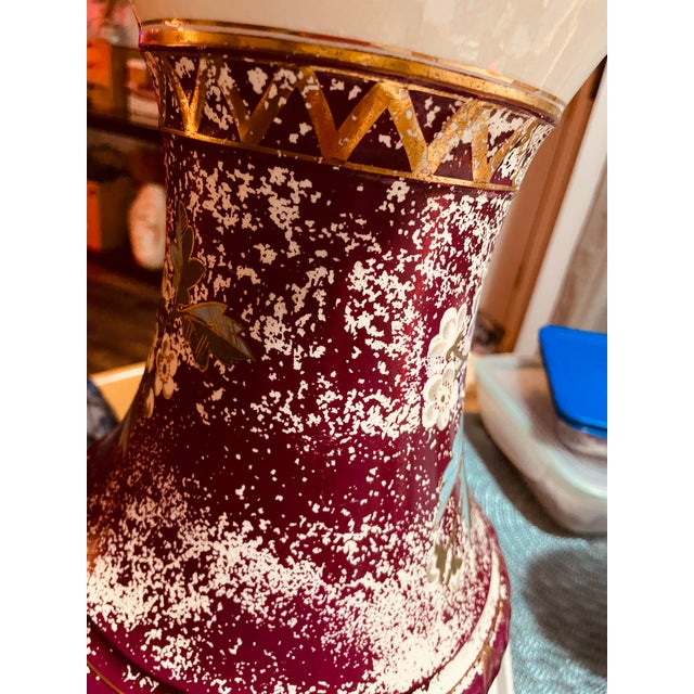 Thie is a Vintage Porcelain Pitcher (or Ewer) elegantly decorated with a maroon-red glaze, then hand-painted with florals,...