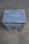 Set of three graduated nesting tables featuring an architectural geometric open-frame base and distressed blue finish with...