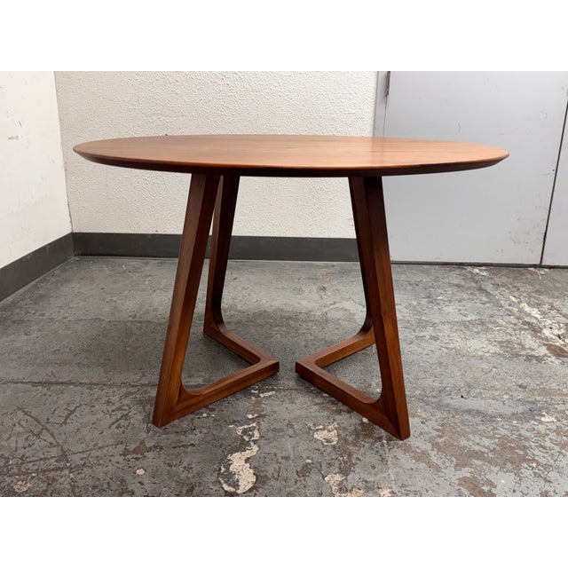 Design Plus Gallery presents the Godenza Dining Table from Moe's Home Collection. The round dining table has a broad wood...