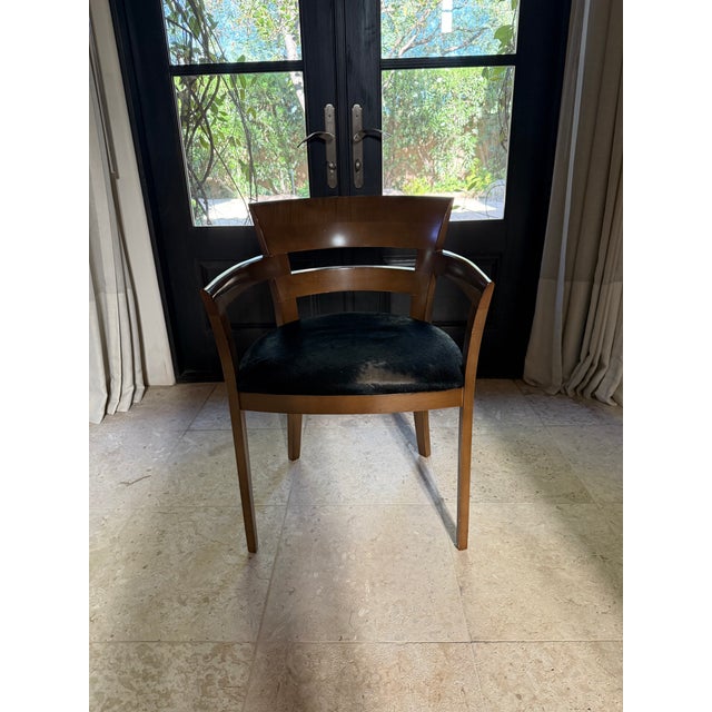 Sculptural pair of Danish Modern armchairs with the clean, organic lines and exposed wood frames that define the era. Warm...