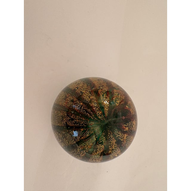 What a beautiful sight this Murano paperweight beholds. It's colors are truly amazing. The 24k gold dust flecks swirls in...