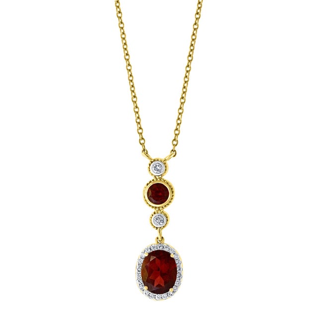 Approximately 6 Carat Oval Shape Garnet & 0.6 Carat Diamond Necklace in 14 Karat Yellow Gold This Simple yet elegant...