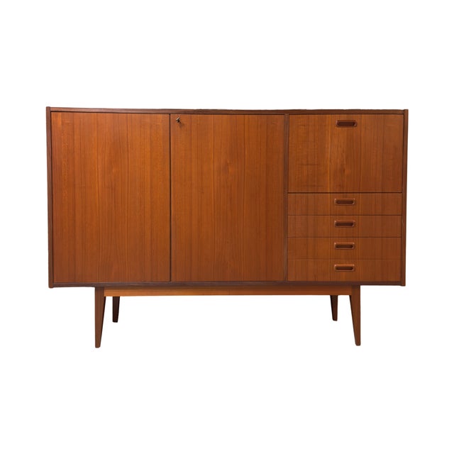 Vintage 1960s mid-century modern teak highboard in the manner of Bertil Fridhagen for Bodafors, Sweden. This beautiful...