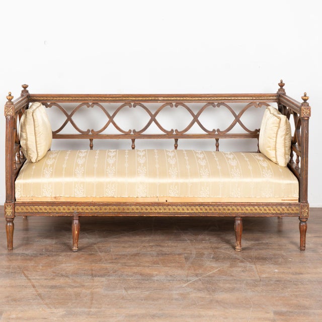 19th century Swedish bench, crafted in pine and retaining its original painted finish. The paint presents in brown tones...