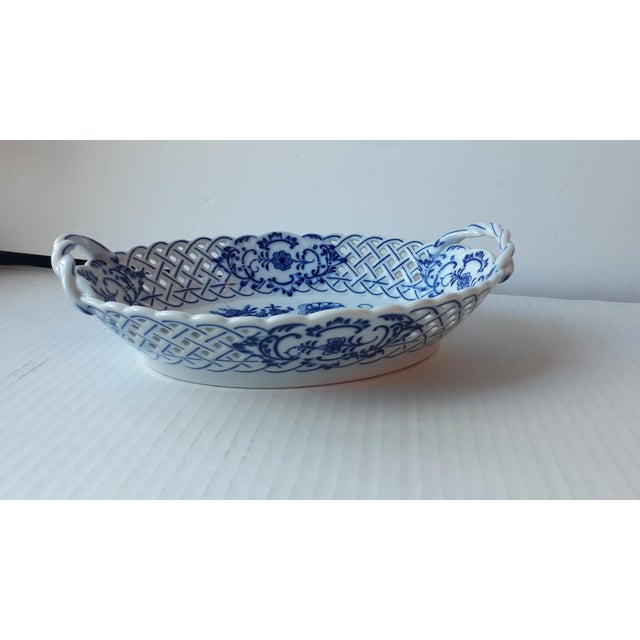 A serving platter with handles/basket by Carl Teichert Meissen. The pattern is Blue Onion and features a white background...