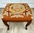 Here is an antique French Louis XV style footstool dating to approximately the turn of the 20th century, with a...