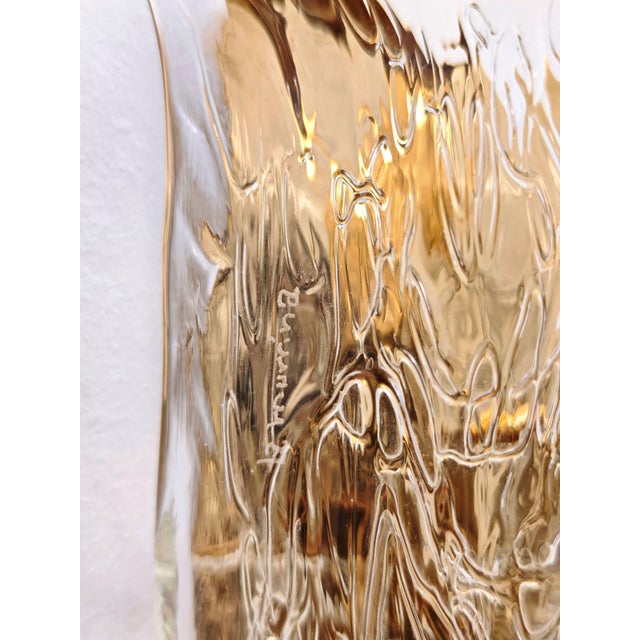 These vintage wall lamps are made of thick, mouth-blown Murano glass, often dating back to the 1970s and 1980s. The design...