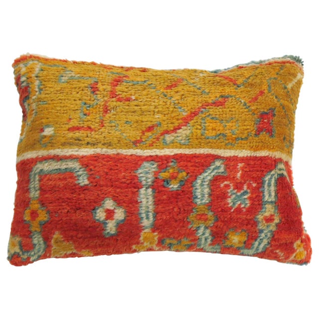 Pillow made from an early 20th century coral and gold color antique Oushak rug Measures: 16" x 23".