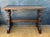 Striking Spanish Rustic trestle console table crafted in solid wood, dating to the mid-20th century. The piece features a...
