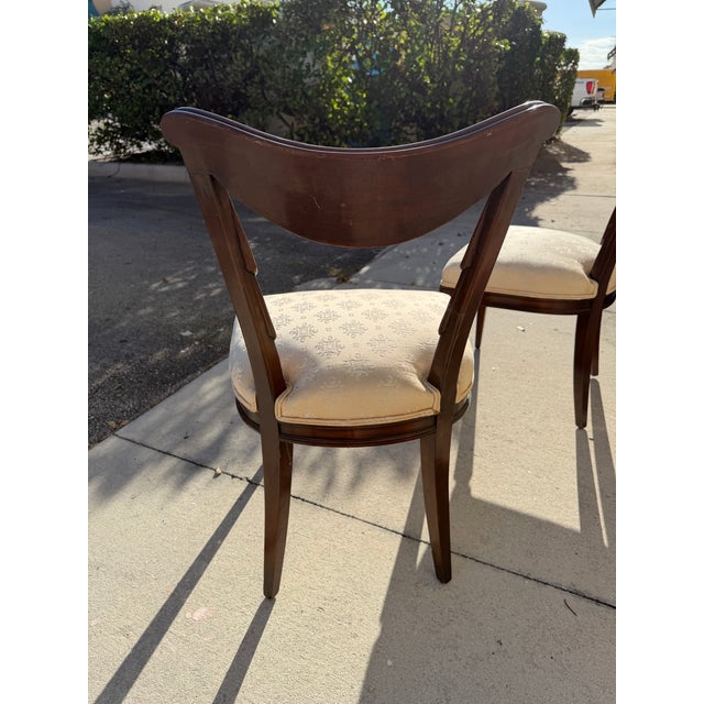 Elegant pair of vintage Regency Revival dining or side chairs, crafted in richly finished wood and distinguished by...