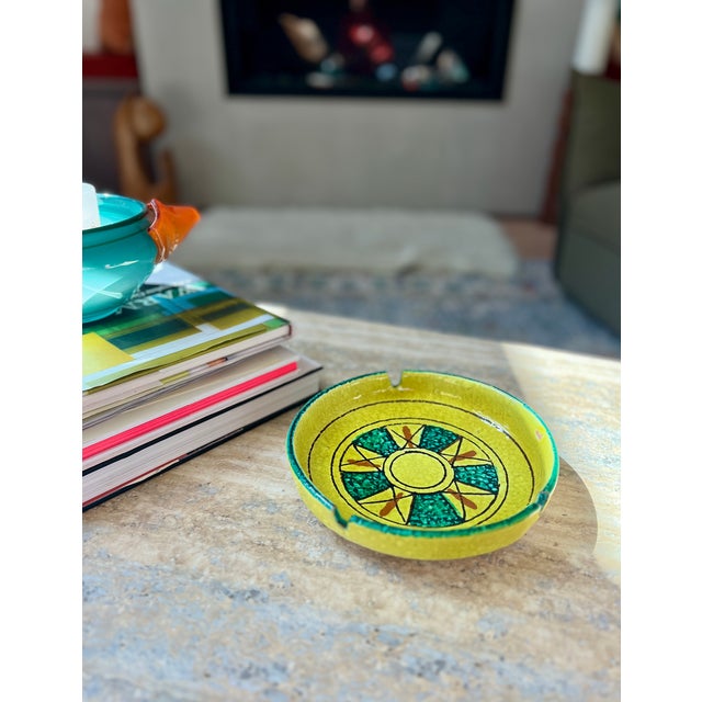 A vibrant 8-inch Italian art pottery ashtray/ catchall featuring a bold lava glaze texture and a hand-painted geometric...