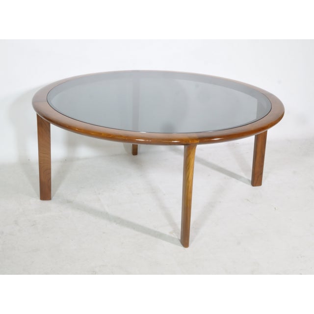 Delicate cherrywood coffee table with a smoked glass top. Design: Wilhelm Knoll Era: 1960s Height: 45 cm Diameter: 107.5...