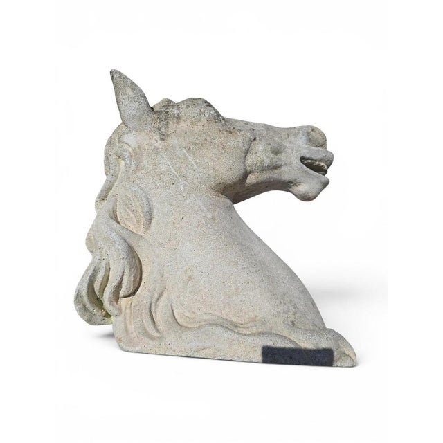 Elegant sculpture depicting a horse’s head, crafted in reconstituted stone during the second half of the 20th century....