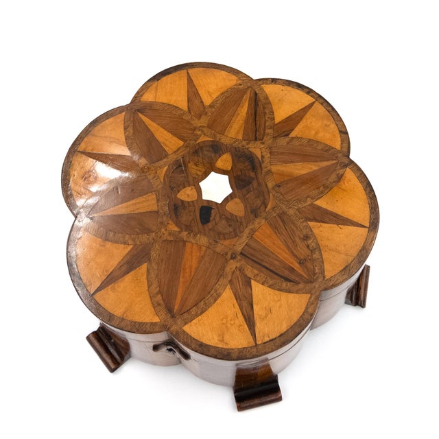 A specimen wood box in the form of a lotus flower, the exterior composed of alternating veneers of satinwood, walnut, and...