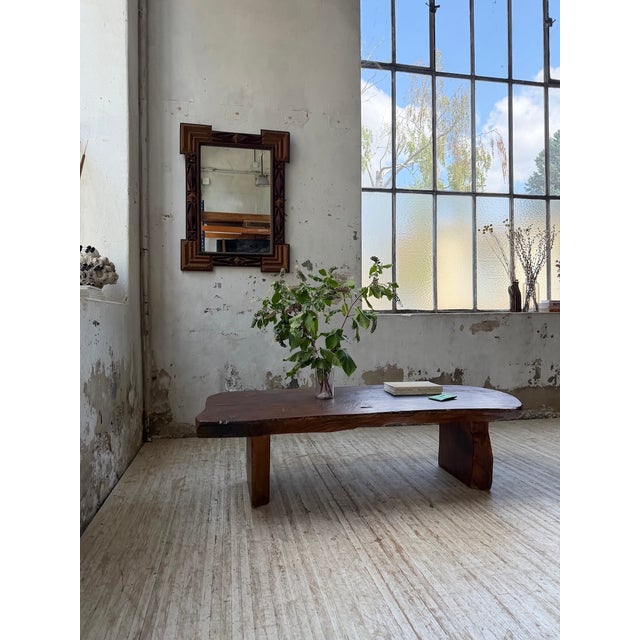 Antique coffee table from an old chalet in the Alps. It features a thick, free-form top resting on a simple base. The wood...