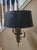 Vintage brass hanging chandelier. The shade is black with a metallic gold/black gimp cord at top and bottom. Inside the...