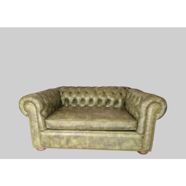 This is a custom made authentic Avery Boardman green leather Chesterfield loveseat sofa, representing the pinnacle of...