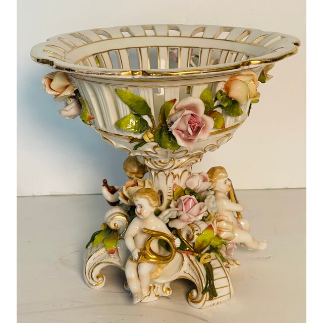 Gorgeous antique porcelain reticulated figural centrepiece compote decorated with Floweers and 3 figures of putti each...