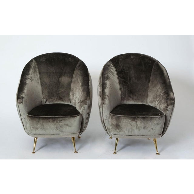 Elegant tub chairs attributed to a 1937 Model by Gio Ponti. The scooped out seat and high backed oblique form is typical...