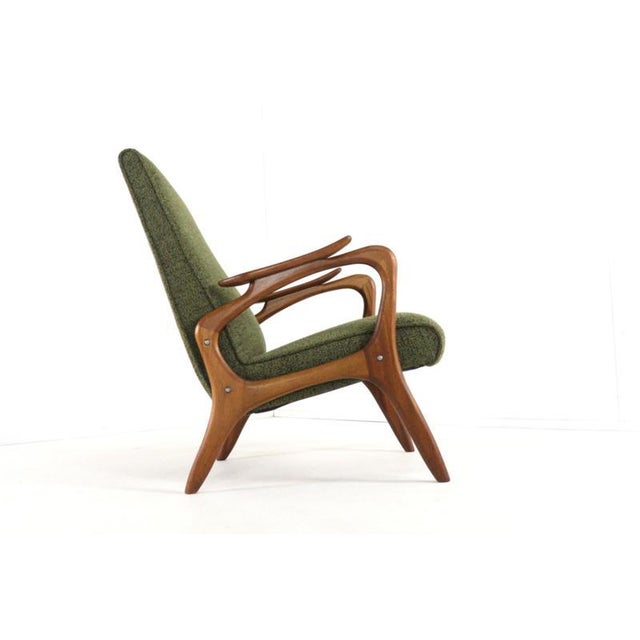 This mid-century modern armchair is an elegant example of organic design from the 1950s and 1960s. The fully restored teak...