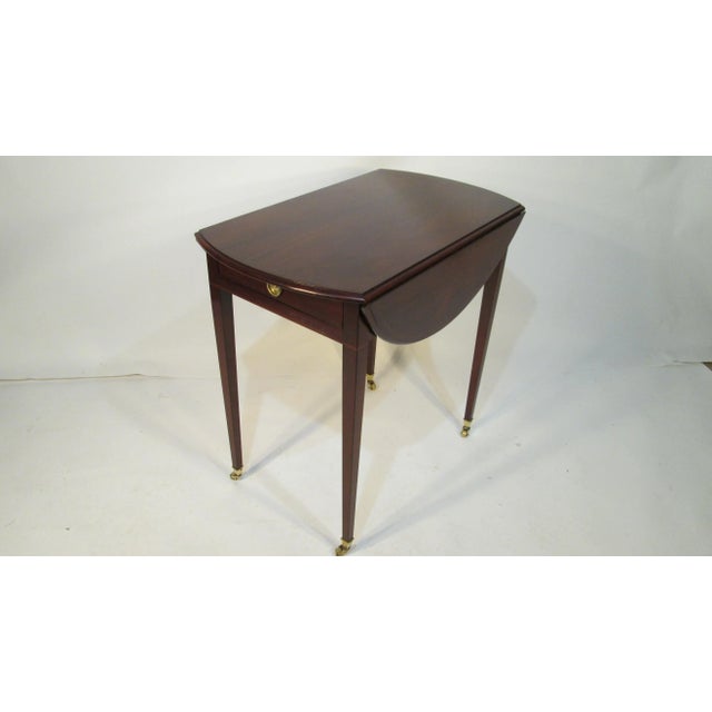 This pembroke table was made by Kaplan furniture from their exclusive Beacon Hill Collection. the table is made of...